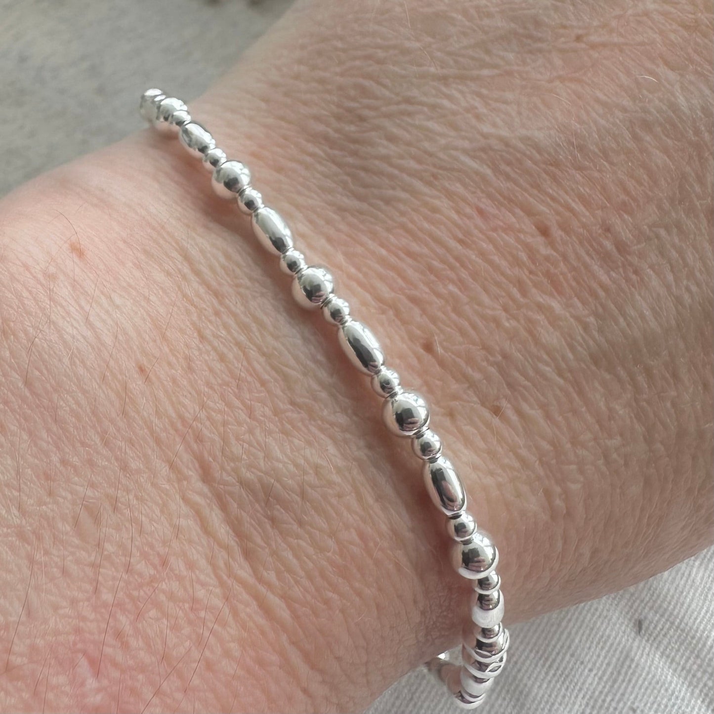 Stretchy Beaded Bracelet with oval beads for Layering, Sterling Silver elastic bracelet