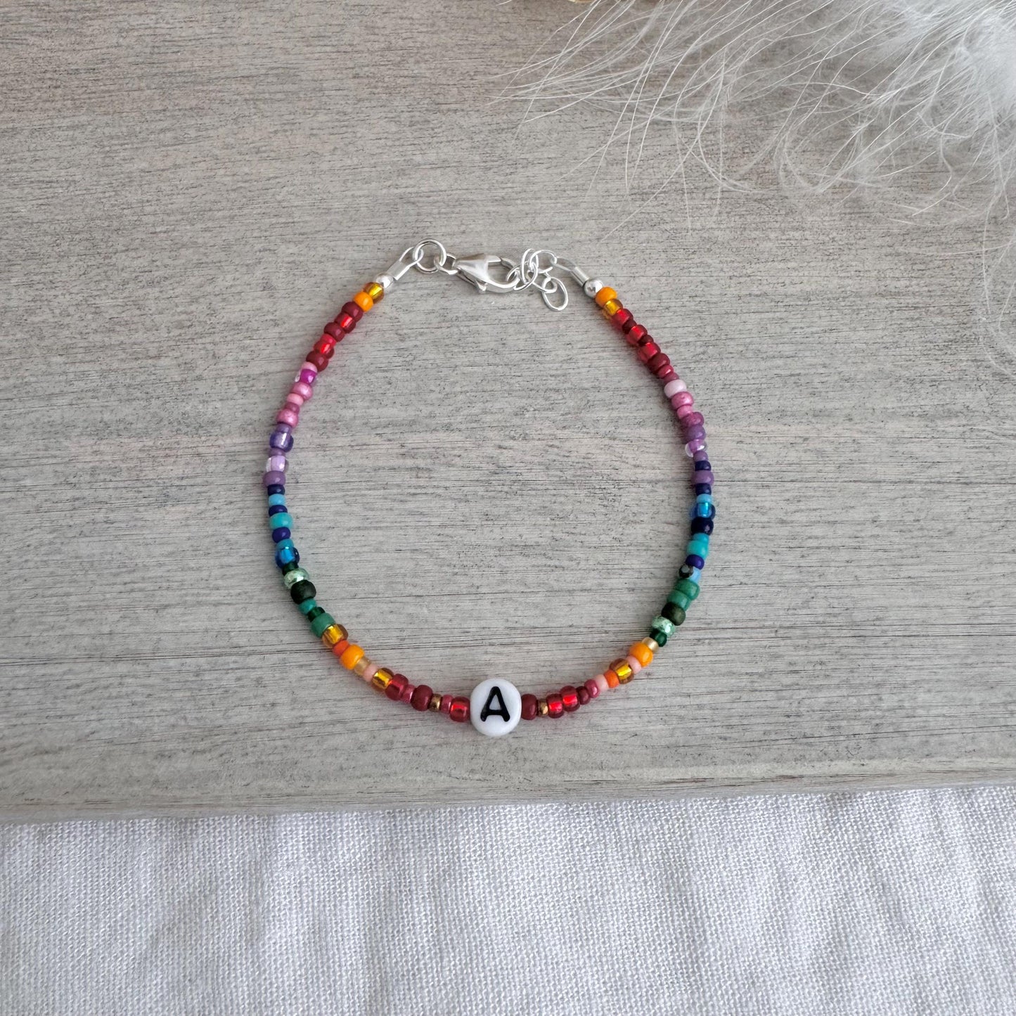 Personalised Rainbow Bracelet with glass seed beads in rainbow colours and a Czech glass letter