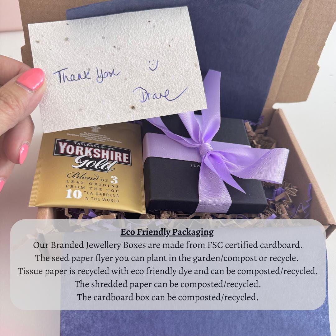 A hand holding a note of thanks next to a gift box with a purple ribbon, and a note about eco-friendly packaging for the jewelry boxes.