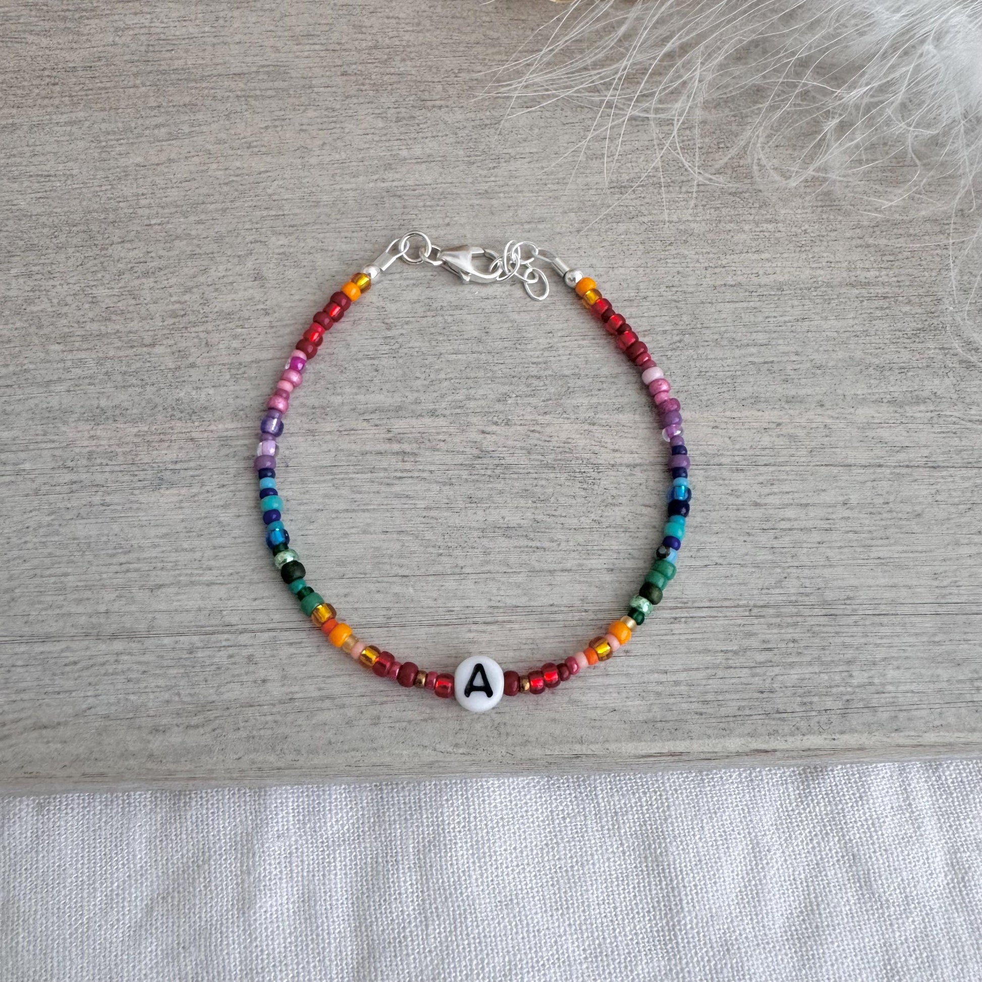 Personalised Rainbow Bracelet with glass seed beads in rainbow colours and a Czech glass letter