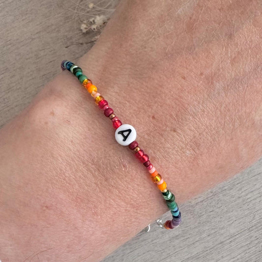 Personalised Rainbow Bracelet with glass seed beads in rainbow colours and a Czech glass letter