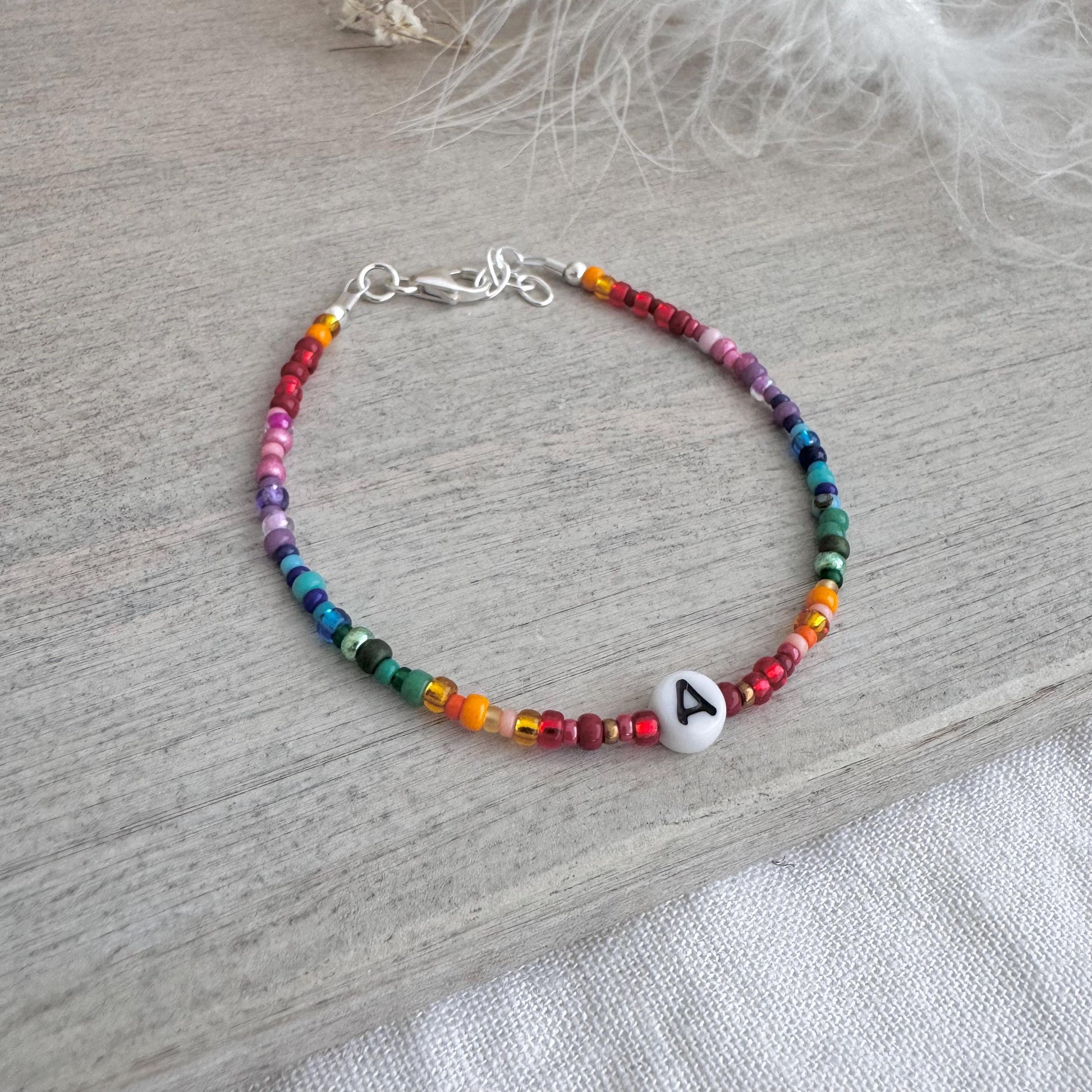 Personalised Rainbow Bracelet with glass seed beads in rainbow colours and a Czech glass letter